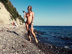 Travel slut teases a videographer and fucks him on the beach